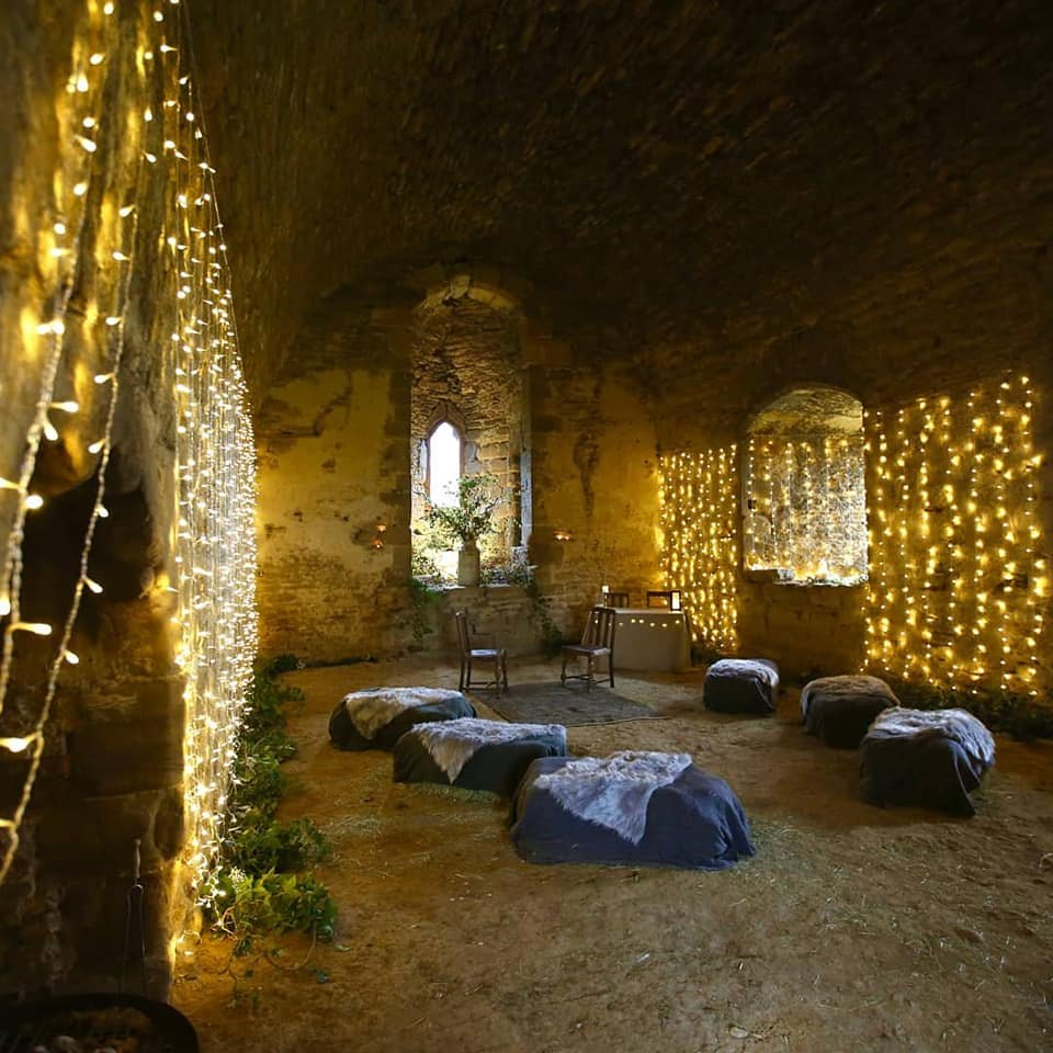 A room dressed with fairy lights and cushions