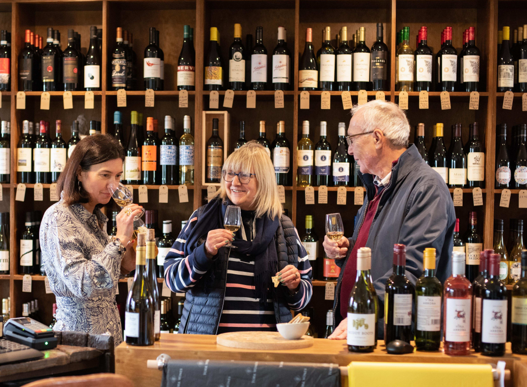 Alex and customers tasting wines in the shop