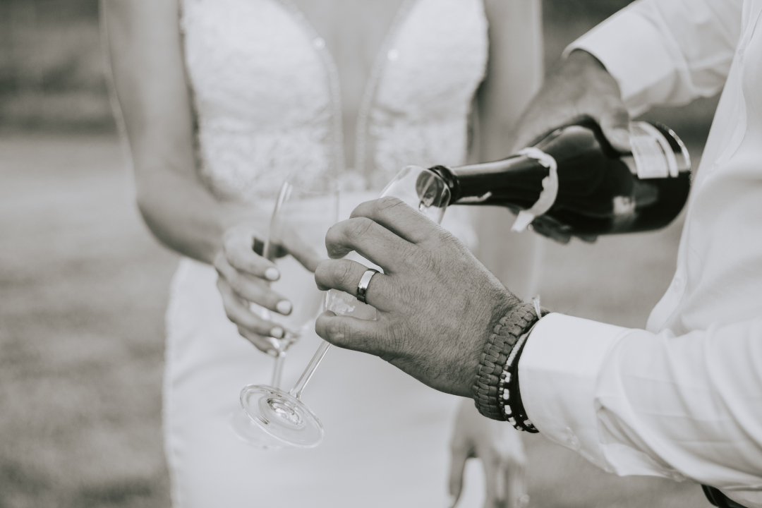 Bride and groom pouring champagne
