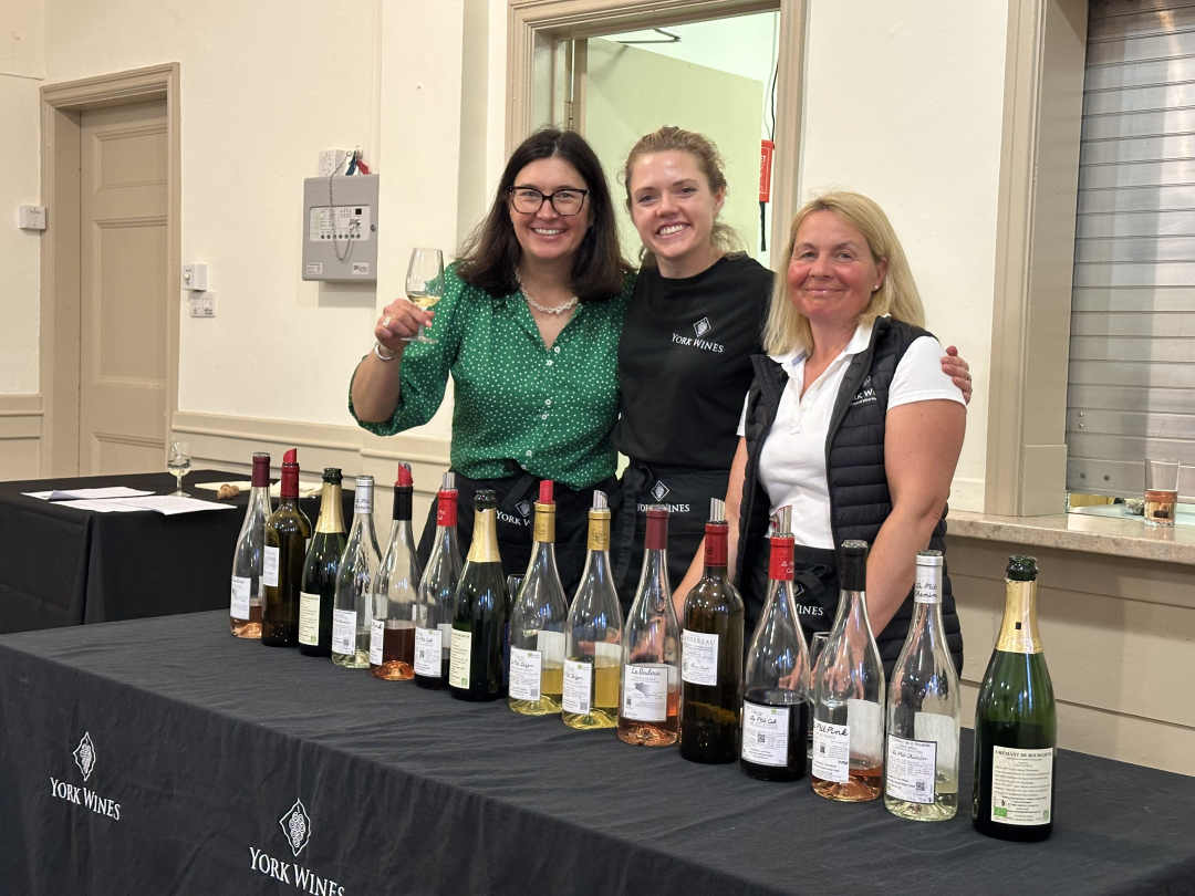 York Wines team toasting with a wine glass at a wine tasting event